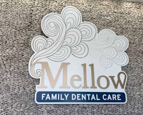Mellow Family Dental Care logo featuring stylized cloud art and modern blue typography.