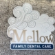 Mellow Family Dental Care logo featuring stylized cloud art and modern blue typography.
