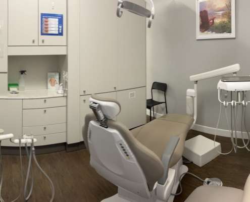 Dentist explaining a procedure to a child, showcasing family-friendly care near Pitt Meadows.