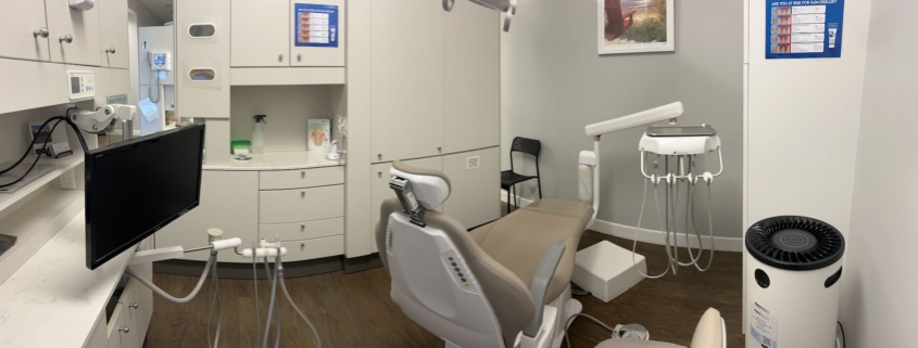 Dentist explaining a procedure to a child, showcasing family-friendly care near Pitt Meadows.