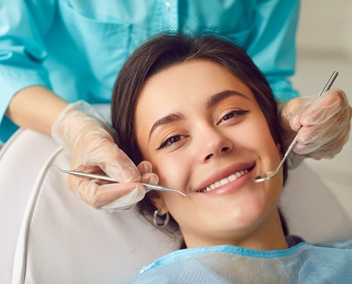A dentist performing a routine checkup for a patient near Pitt Meadows.