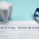Dental insurance claim form with a tooth model, representing direct billing in Maple Ridge.
