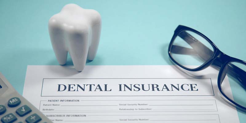 Dental insurance claim form with a tooth model, representing direct billing in Maple Ridge.