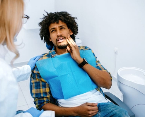 Patient with tooth pain receiving emergency dental care in Maple Ridge.