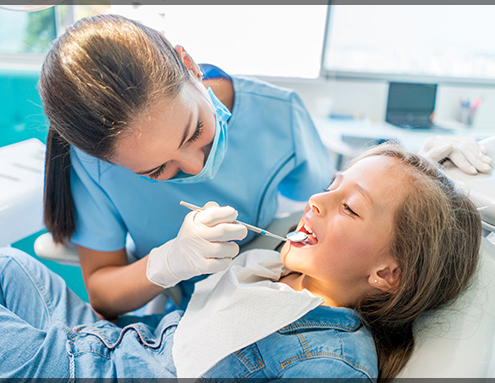 Gentle pediatric dentist near Pitt Meadows performing a comfortable checkup for a young child.