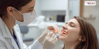 A dental professional providing urgent care for a patient near Pitt Meadows.