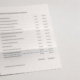 A posted dental statement beside its envelope with one line item underlined in teal, representing the charge left after insurance pays.