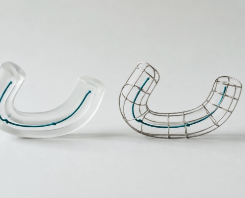 A frosted acrylic arch and a matching wire arch shown side by side at equal weight, representing clear aligners compared with fixed braces.