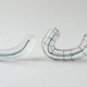 A frosted acrylic arch and a matching wire arch shown side by side at equal weight, representing clear aligners compared with fixed braces.