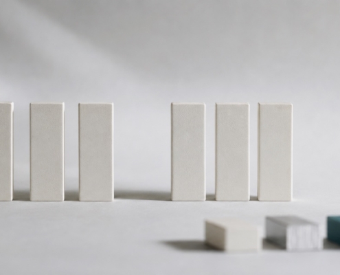 A row of upright blocks with a gap where one is missing, and three alternative blocks nearby, representing bridge, denture, and implant options.
