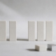 A row of upright blocks with a gap where one is missing, and three alternative blocks nearby, representing bridge, denture, and implant options.